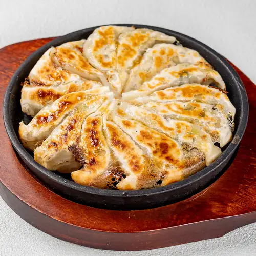 [Piping Hot] 15 bite-sized dumplings served on a hot plate.