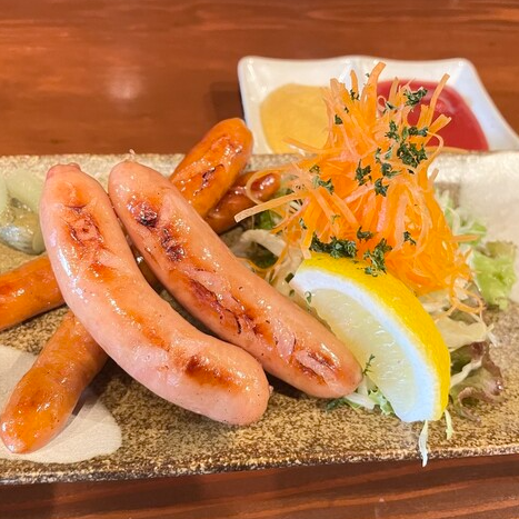 Assortment of chestnut pork sausage and chorizo with curry dip