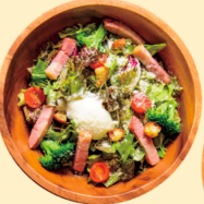 Caesar salad with thick-sliced bacon and soft-boiled eggs