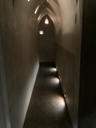 The passage to the store has the atmosphere of a cave or a church