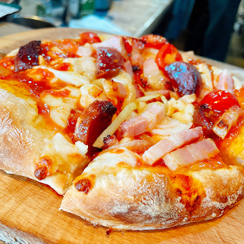 Iberian salami, bacon, onion tomato pizza