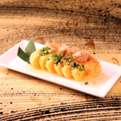 Rolled egg in bonito broth with grated shaved ice sauce