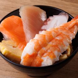 Bowl of rice topped with sashimi