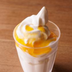 Soft serve ice cream with mango sauce