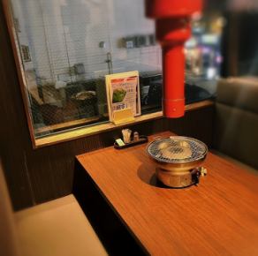 Window table seats on the second floor.Enjoying the city lights.All seats are equipped with smokeless roasters.