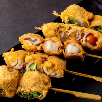 Assortment of 5 skewers of fried vegetables and meat