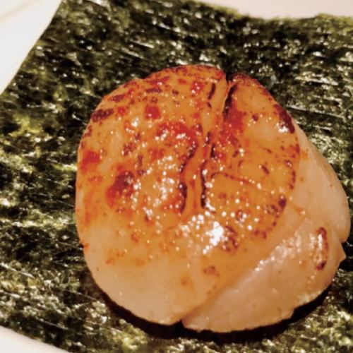 Grilled raw scallops wrapped in seaweed