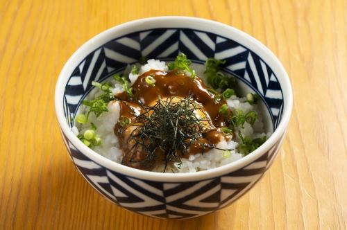 Sea urchin and soy sauce with raw egg on rice