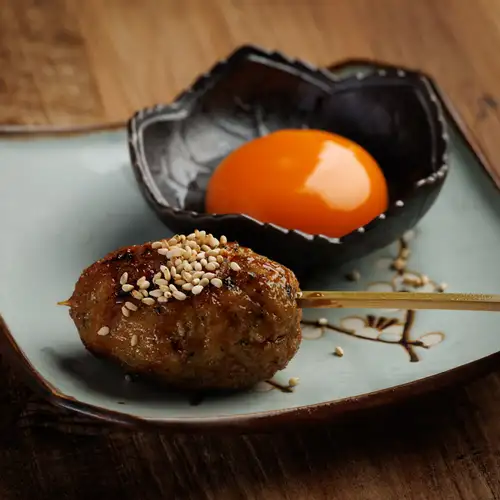 Handmade chicken meatballs with soft-boiled egg and tsukimi (moon-viewing) topping