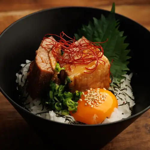 Braised pork belly and rice topped with egg yolk
