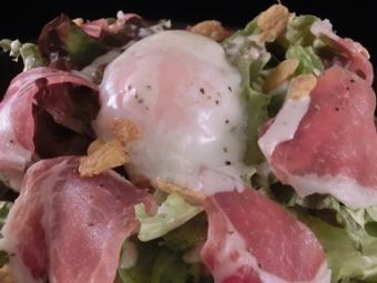 Caesar salad with soft-boiled egg and prosciutto