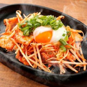 Stir-fried pork and kimchi on an iron plate