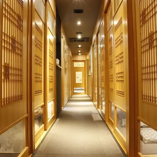 The interior, featuring a wood-based design, offers a carefully selected range of wines.