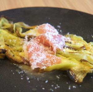 Oven-baked young corn with husk and prosciutto
