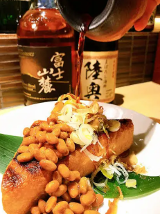 Grilled triangular fried tofu topped with natto