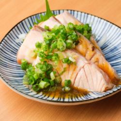 Grilled salmon covered in green onions