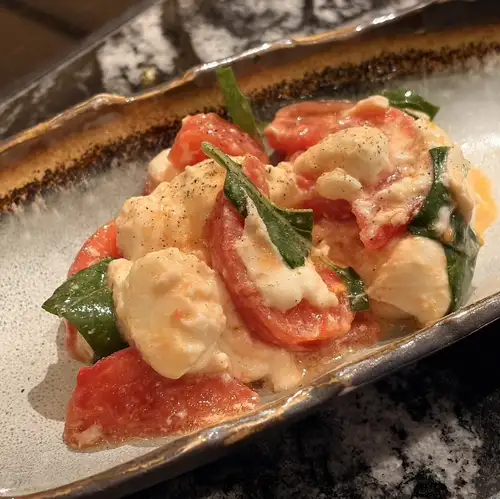 Buffalo mozzarella caprese with tomatoes or fruit of the day