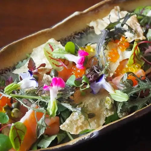 Salmon marinated and fried tofu skin salad