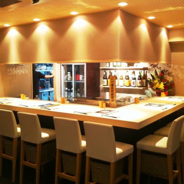 Spacious counter seating surrounds the grill and the displayed alcohol.The seats are spacious and calm, and visually pleasing.