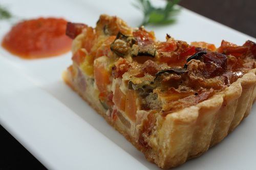 Homemade quiche with bacon and farm vegetables