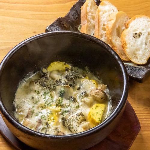 Stone-grilled whelks with escargot-style baguette