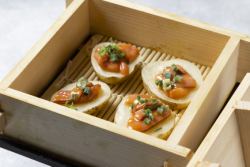 Potatoes and salted fish steamed in a bamboo steamer