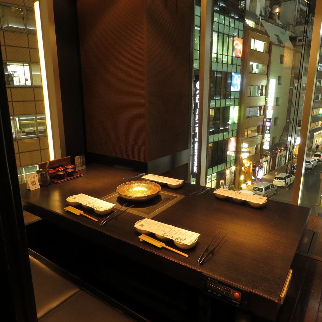 The partitioned table seats offer a panoramic view of the nightscape.