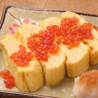 Rolled egg topped with salmon roe