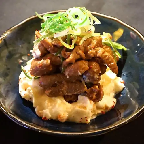 Potato salad with stewed offal