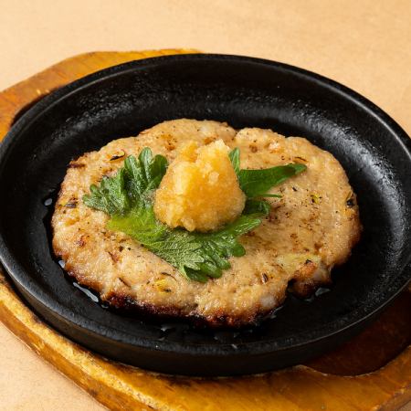 Homemade hand-kneaded meatballs on a hot plate with Japanese-style grated radish