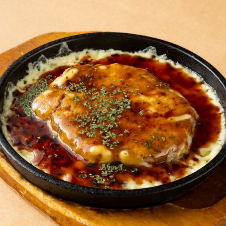 Homemade hand-kneaded meatballs on a hot plate with cheese