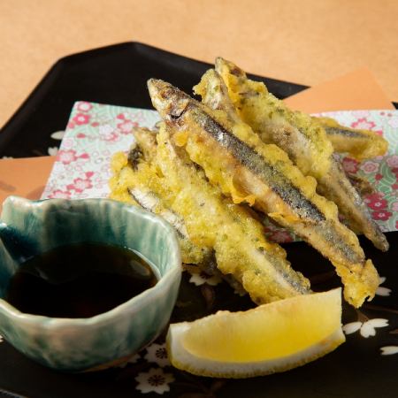 Fried silver-striped round herring with seaweed