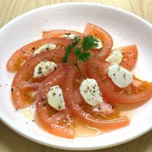 chilled tomato topped with cream cheese