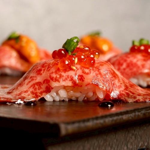 Wagyu beef sushi topped with salmon roe