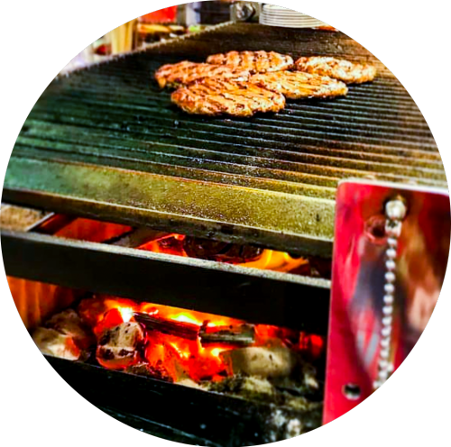 Steaks and hamburgers grilled using Bincho charcoal and straw