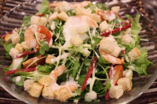 Caesar salad with soft-boiled egg and shrimp